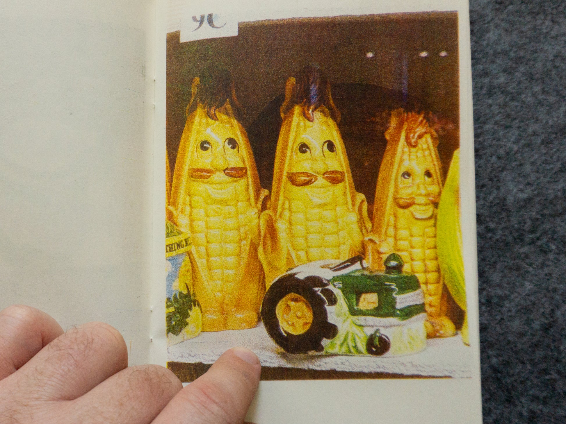 Anthropomorphic corn salt and pepper shakers with a tractor shaker in front.