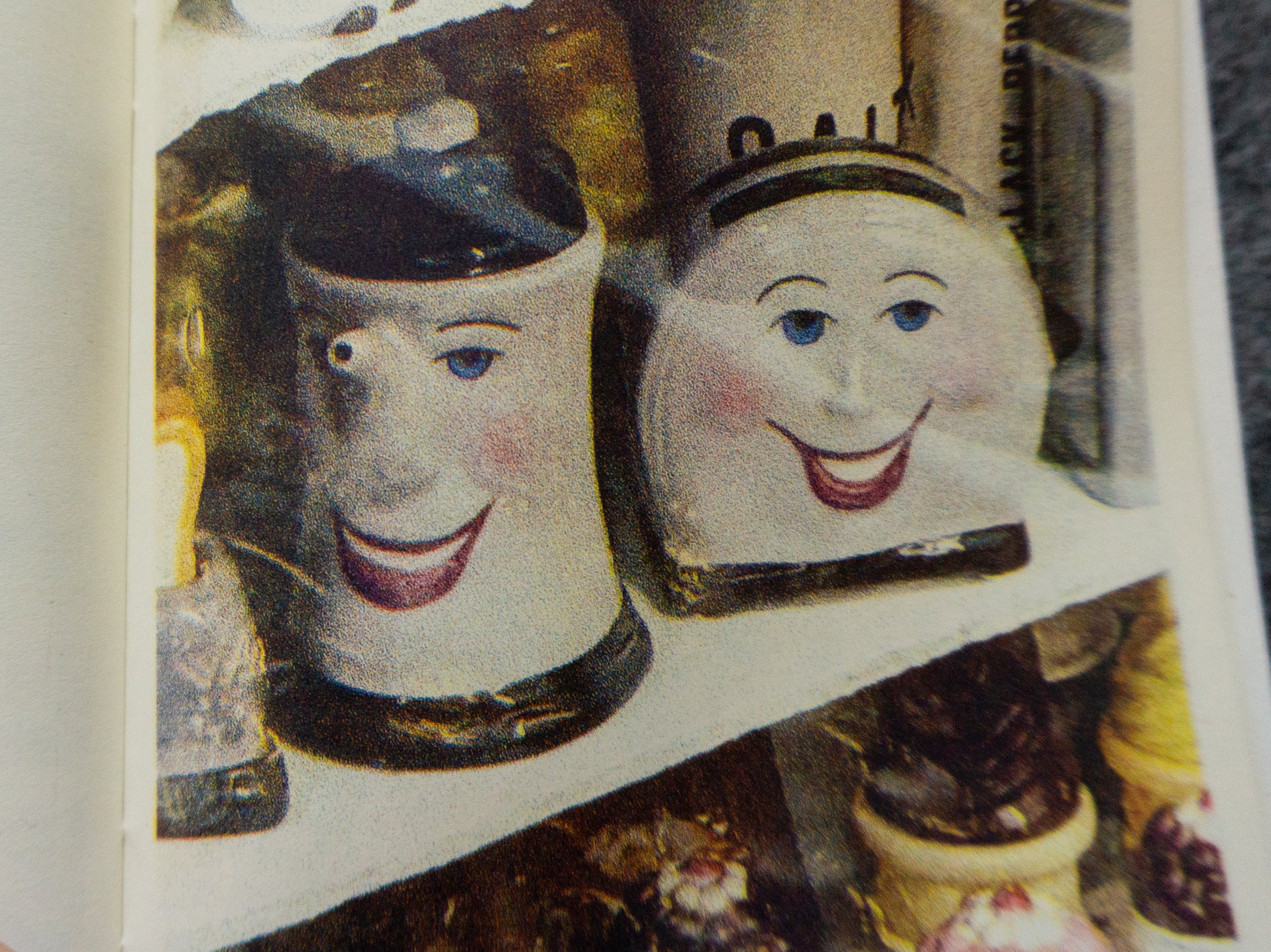 Detail image of a toaster and kettle with smiling faces; also salt and pepper shakers.